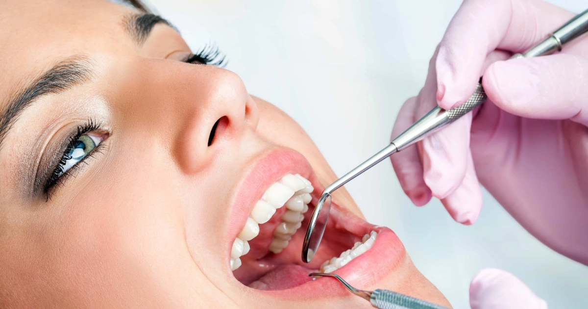 Doctor examining patient’s gums for gingivectomy in Mount Pleasant, SC